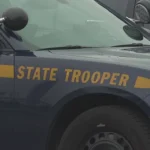 New York State Police cruiser parked outside a barracks after an arrest in Corinth